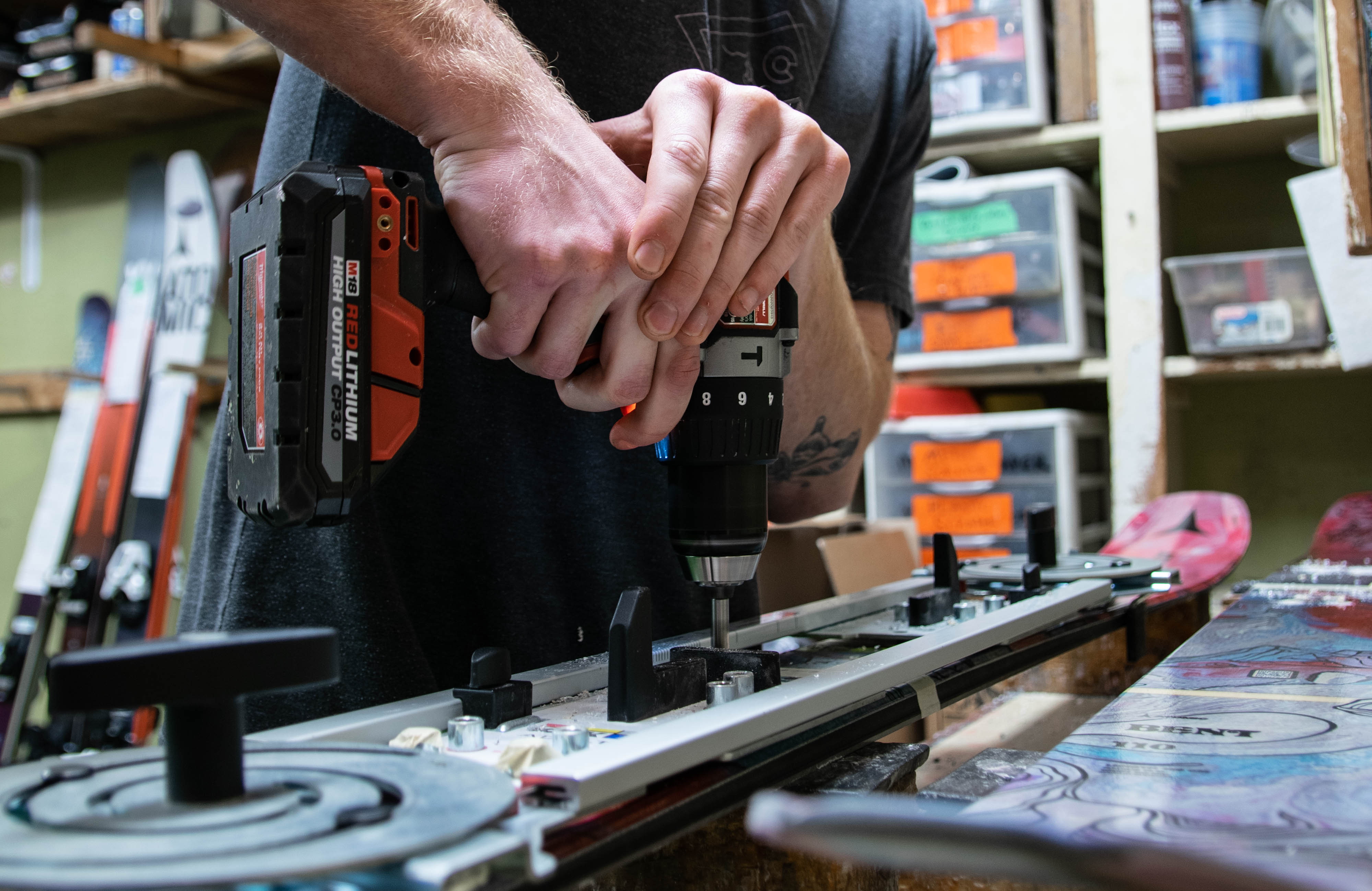 Ski technician mounting skis